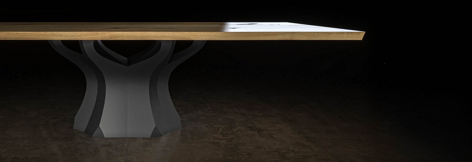 Oak dining table with Baobab sculptural base on a dark backdrop