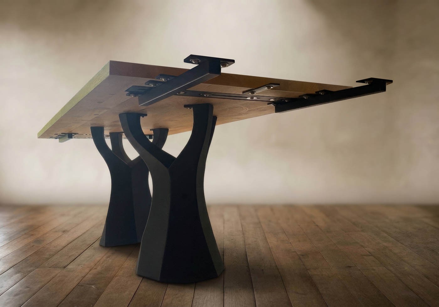 Two steel extension supports bolted into invisible fittings under the table top