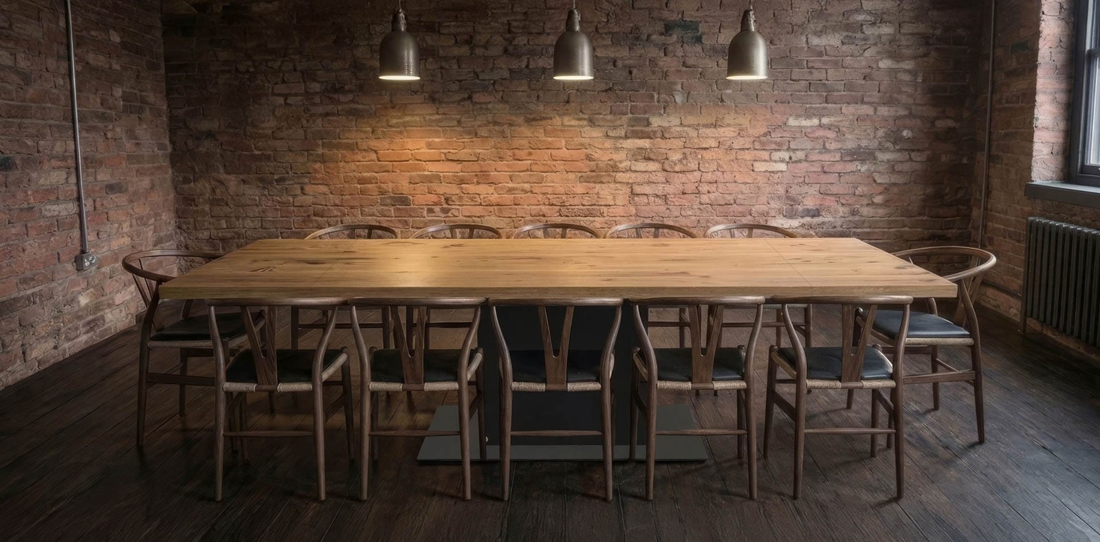 The same oak dining table fully extended with a leaf at each end, seating ten