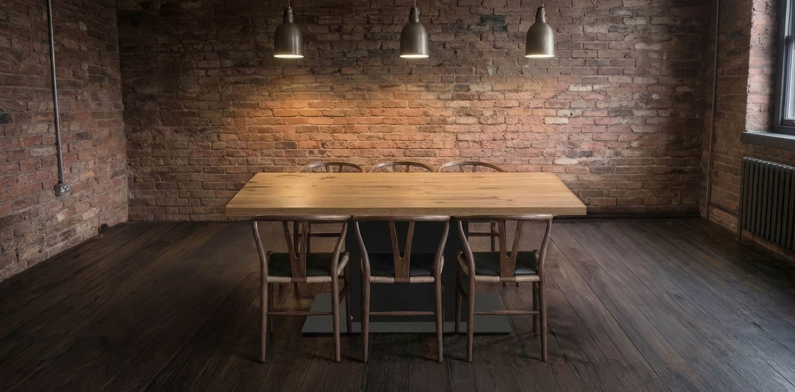 Solid oak dining table, unextended, seating six, in a brick loft dining room